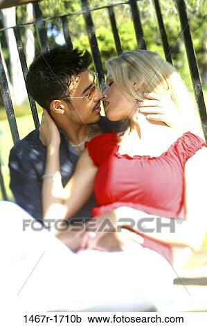 Stock Image - Young couple kissing. Fotosearch