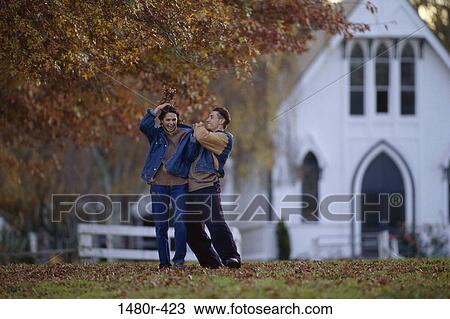 Stock Image - Young couple playing together. Fotosearch