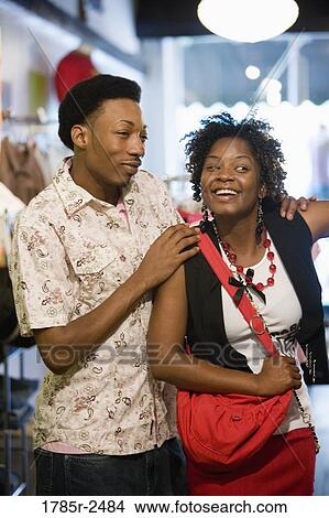 Young couple shopping in a boutique View Large Photo Image Picture - Young couple shopping in a boutique. Fotosearch