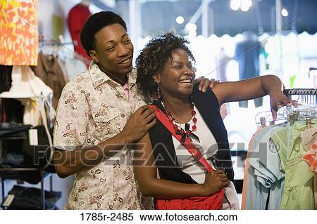 Young couple shopping in a boutique View Large Photo Image Stock Photography - Young couple shopping in a boutique. Fotosearch