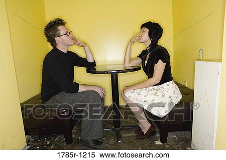 Young couple smoking cigarettes face to face View Large Photo Image Stock Photography - Young couple smoking cigarettes face to face. Fotosearch