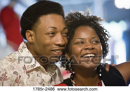 Young couple standing in a boutique View Large Photo Image Stock Photograph - Young couple standing in a boutique. Fotosearch