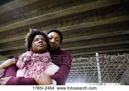 Young couple standing under a highway overpass View Large Photo Image Picture - Young couple standing under a highway overpass. Fotosearch