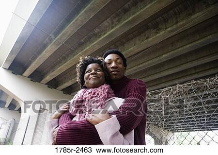 Young couple standing under a highway overpass View Large Photo Image Stock Image - Young couple standing under a highway overpass. Fotosearch