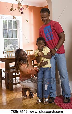 Stock Photo - Young couple with daughter at home. Fotosearch