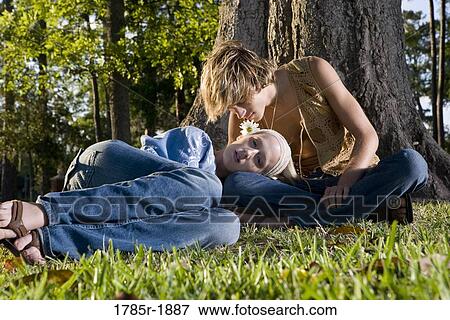Young hippie couple relaxing under tree View Large Photo Image Stock Photo - Young hippie couple relaxing under tree. Fotosearch