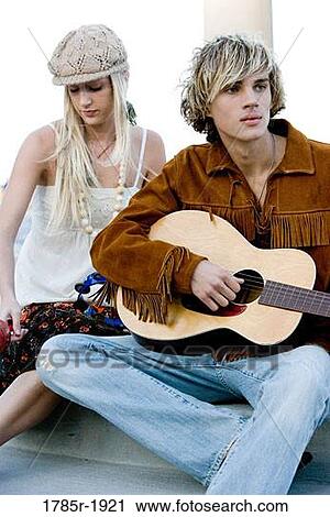 Young hippie couple with guitar View Large Photo Image Stock Image - Young hippie couple with guitar. Fotosearch