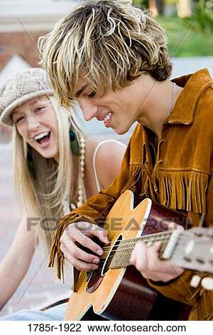 Young hippie couple with guitar View Large Photo Image Stock Image - Young hippie couple with guitar. Fotosearch