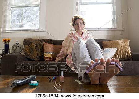 Young Hispanic woman giving herself a pedicure View Large Photo Image Picture - Young Hispanic woman giving herself a pedicure. Fotosearch
