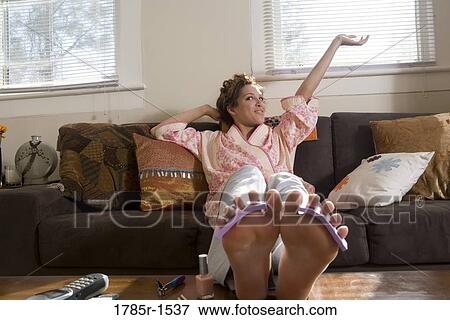 Young Hispanic woman giving herself a pedicure View Large Photo Image Stock Photo - Young Hispanic woman giving herself a pedicure. Fotosearch