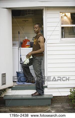 Young man doing household chores View Large Photo Image Stock Photo - Young man doing household chores. Fotosearch