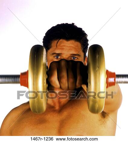 Young man lifting a dumbbell View Large Photo Image Stock Photograph - Young man lifting a dumbbell. Fotosearch