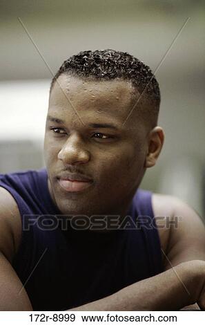 Stock Photo - Young man looking sideways. Fotosearch
