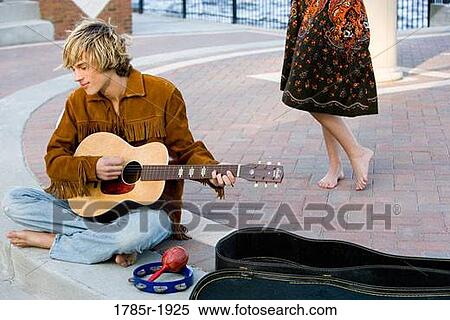 Young man playing guitar View Large Photo Image Stock Photography - Young man playing guitar. Fotosearch
