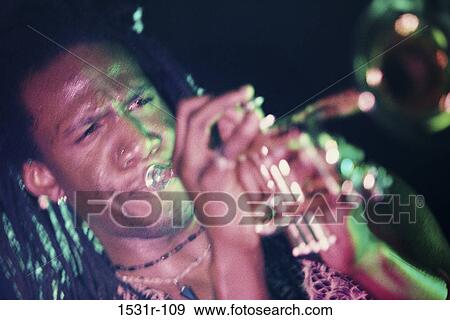 Young man playing the trumpet View Large Photo Image Stock Photo - Young man playing the trumpet. Fotosearch