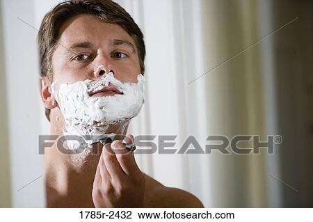 Young man shaving View Large Photo Image Stock Image - Young man shaving. Fotosearch