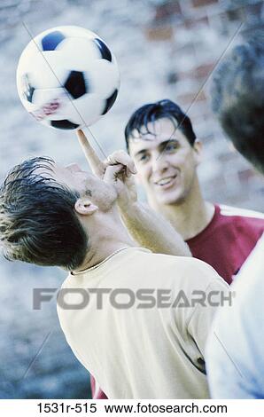 Young man spinning a soccer ball on his finger View Large Photo Image Stock Photography - Young man spinning a soccer ball on his finger. Fotosearch