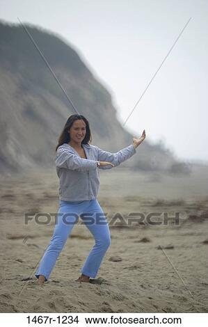 Young woman exercising on the beach View Large Photo Image Picture - Young woman exercising on the beach. Fotosearch