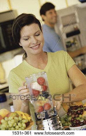 Young woman making a fruit puree in a blender View Large Photo Image Stock Image - Young woman making a fruit puree in a blender. Fotosearch