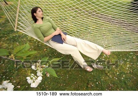 Stock Photo - Young woman sleeping in a hammock. Fotosearch