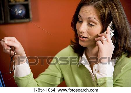 Picture - Young woman talking on mobile phone. Fotosearch