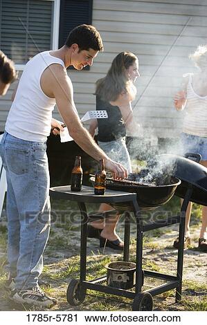 A blue-collar family enjoying a cookout in front of a trailer home View Large Photo Image Stock Image - A blue-collar family enjoying a cookout in front of a trailer home. Fotosearch