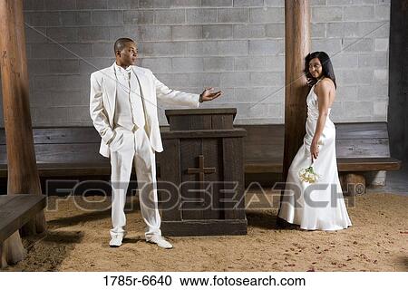 A bride and a groom next to an altar inside a medieval castle View Large Photo Image Stock Image - A bride and a groom next to an altar inside a medieval castle. Fotosearch