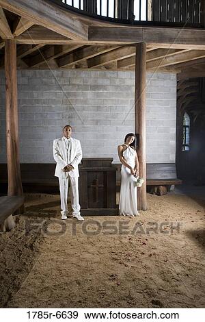 A bride and a groom next to an altar inside a medieval castle View Large Photo Image Stock Photo - A bride and a groom next to an altar inside a medieval castle. Fotosearch