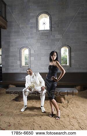 Stock Image - A couple in formal attire in a medieval castle. Fotosearch