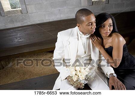Stock Image - A couple in formal attire in a medieval castle. Fotosearch