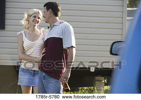 A couple standing by a old van, in front of trailer home View Large Photo Image Stock Image - A couple standing by a old van, in front of trailer home. Fotosearch