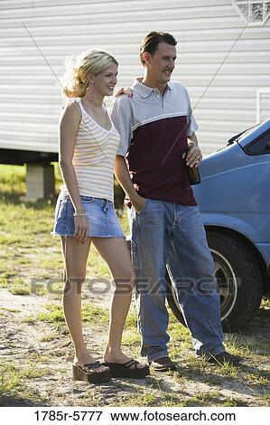 A couple standing by a old van, in front of trailer home View Large Photo Image Stock Photo - A couple standing by a old van, in front of trailer home. Fotosearch