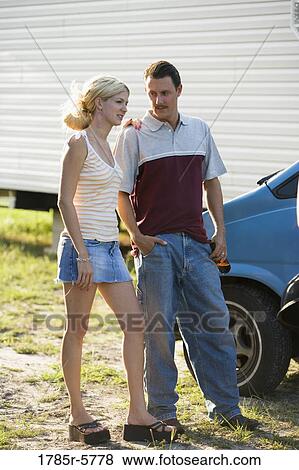 A couple standing by a old van, in front of trailer home View Large Photo Image Stock Photo - A couple standing by a old van, in front of trailer home. Fotosearch