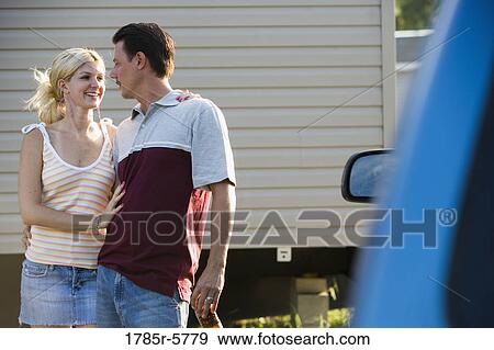A couple standing by a old van, in front of trailer home View Large Photo Image Stock Photo - A couple standing by a old van, in front of trailer home. Fotosearch