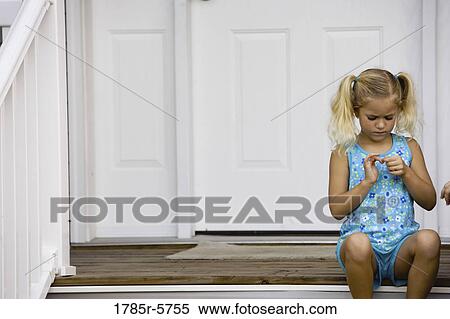 A cute little girl sitting by front door View Large Photo Image Stock Photography - A cute little girl sitting by front door. Fotosearch