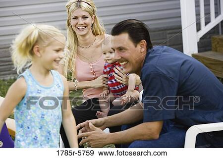 Stock Photo - A family sitting together. Fotosearch