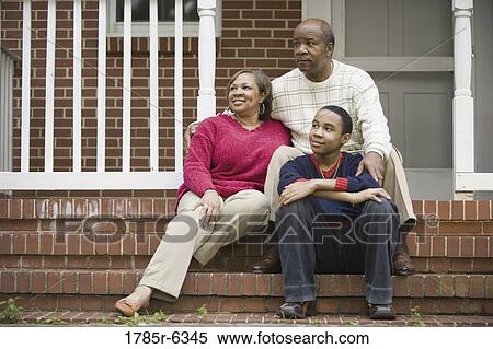 A family with a teenage son sitting on front porch of house View Large Photo Image Stock Photography - A family with a teenage son sitting on front porch of house. Fotosearch