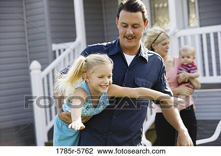 A man playing with his daughter in front yard View Large Photo Image Stock Image - A man playing with his daughter in front yard. Fotosearch