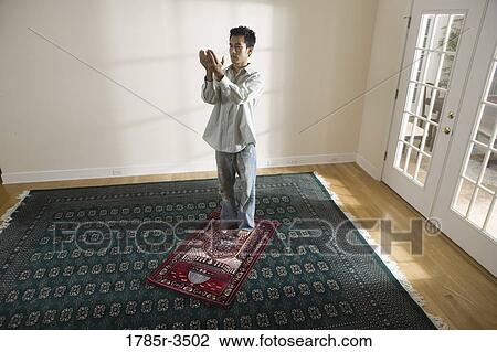 A Muslim man praying on a prayer mat View Large Photo Image Stock Image - A Muslim man praying on a prayer mat. Fotosearch