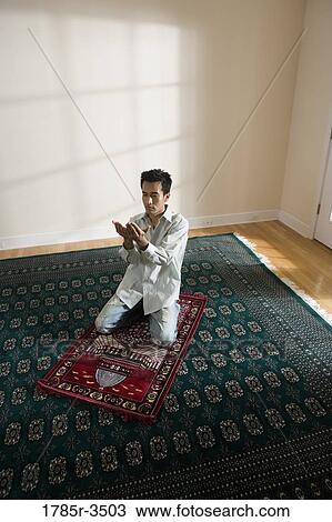 A Muslim man praying on a prayer mat View Large Photo Image Stock Image - A Muslim man praying on a prayer mat. Fotosearch