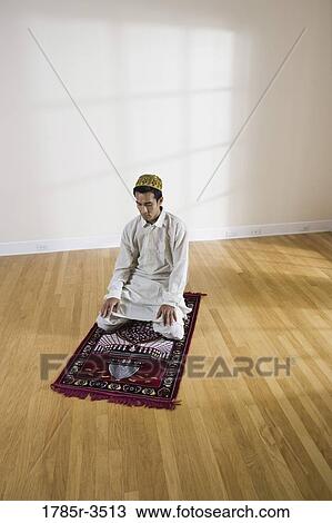 A Muslim man praying on a prayer mat View Large Photo Image Stock Image - A Muslim man praying on a prayer mat. Fotosearch
