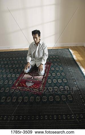 A Muslim man praying on a prayer mat View Large Photo Image Stock Photo - A Muslim man praying on a prayer mat. Fotosearch
