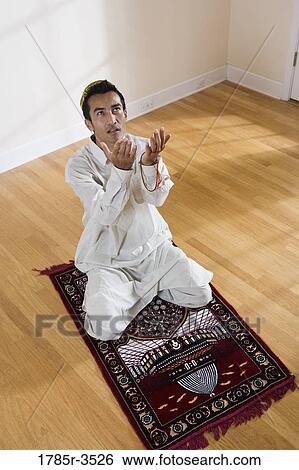 A Muslim man praying on a prayer mat View Large Photo Image Stock Photograph - A Muslim man praying on a prayer mat. Fotosearch