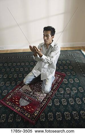A Muslim man praying on a prayer mat View Large Photo Image Stock Photography - A Muslim man praying on a prayer mat. Fotosearch