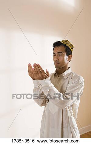 Stock Photograph - A Muslim man praying. Fotosearch