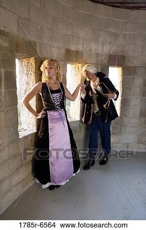 A navy officer greeting and kissing the hand of a princess in the turret of a castle View Large Photo Image Picture - A navy officer greeting and kissing the hand of a princess in the turret of a castle. Fotosearch