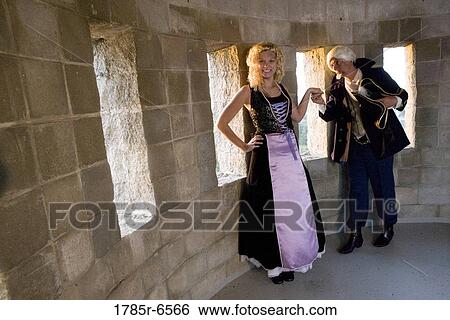 A navy officer greeting and kissing the hand of a princess in the turret of a castle View Large Photo Image Stock Photograph - A navy officer greeting and kissing the hand of a princess in the turret of a castle. Fotosearch