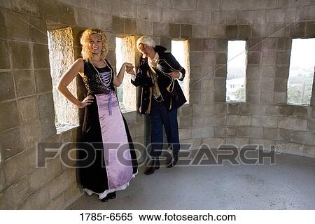 A navy officer greeting and kissing the hand of a princess in the turret of a castle View Large Photo Image Stock Photography - A navy officer greeting and kissing the hand of a princess in the turret of a castle. Fotosearch