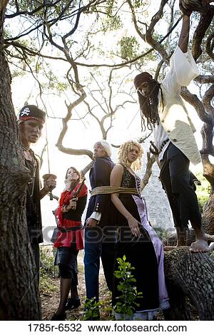 A princess in a purple gown and a navy officer held captive by armed pirates View Large Photo Image Stock Image - A princess in a purple gown and a navy officer held captive by armed pirates. Fotosearch