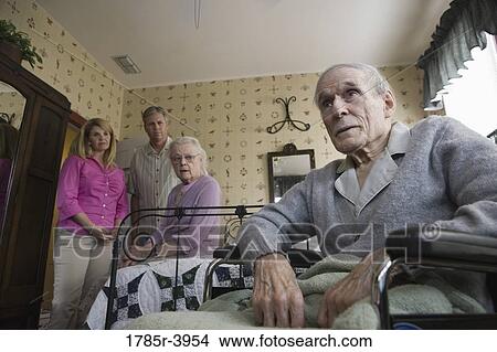 Adult children visiting and comforting senior parents in bedroom View Large Photo Image Picture - Adult children visiting and comforting senior parents in bedroom. Fotosearch